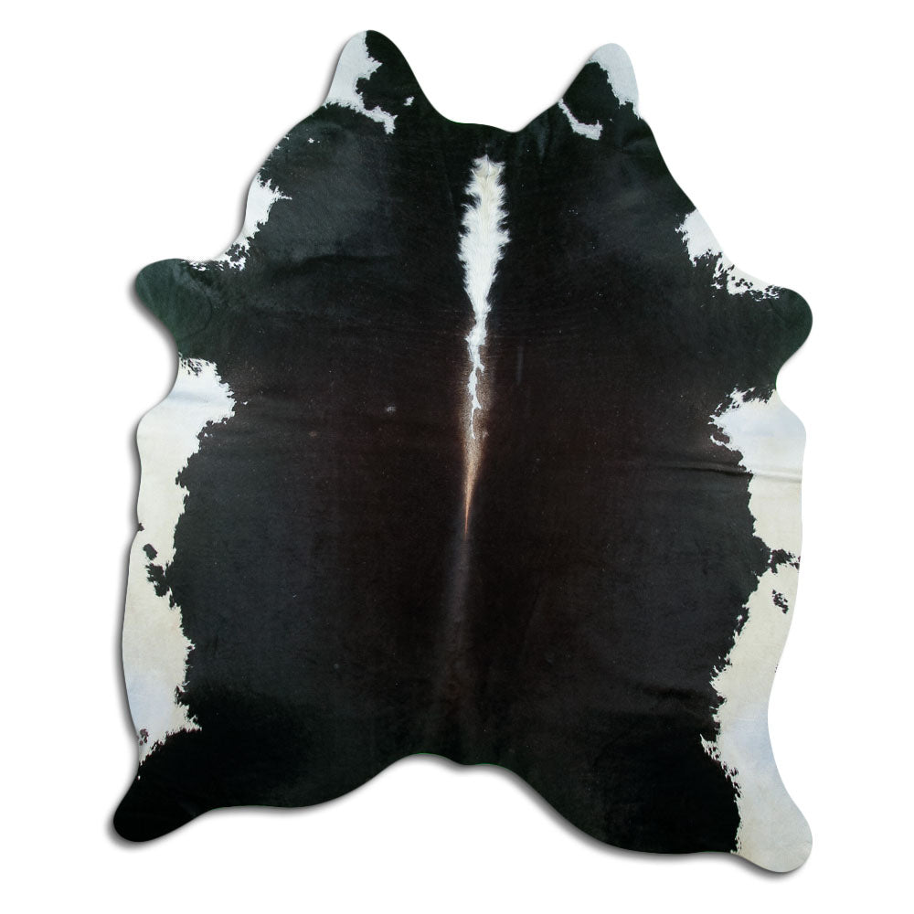 Black and white cowhide rug of about 210 × 180 cm, seen from above: the exact hide you receive