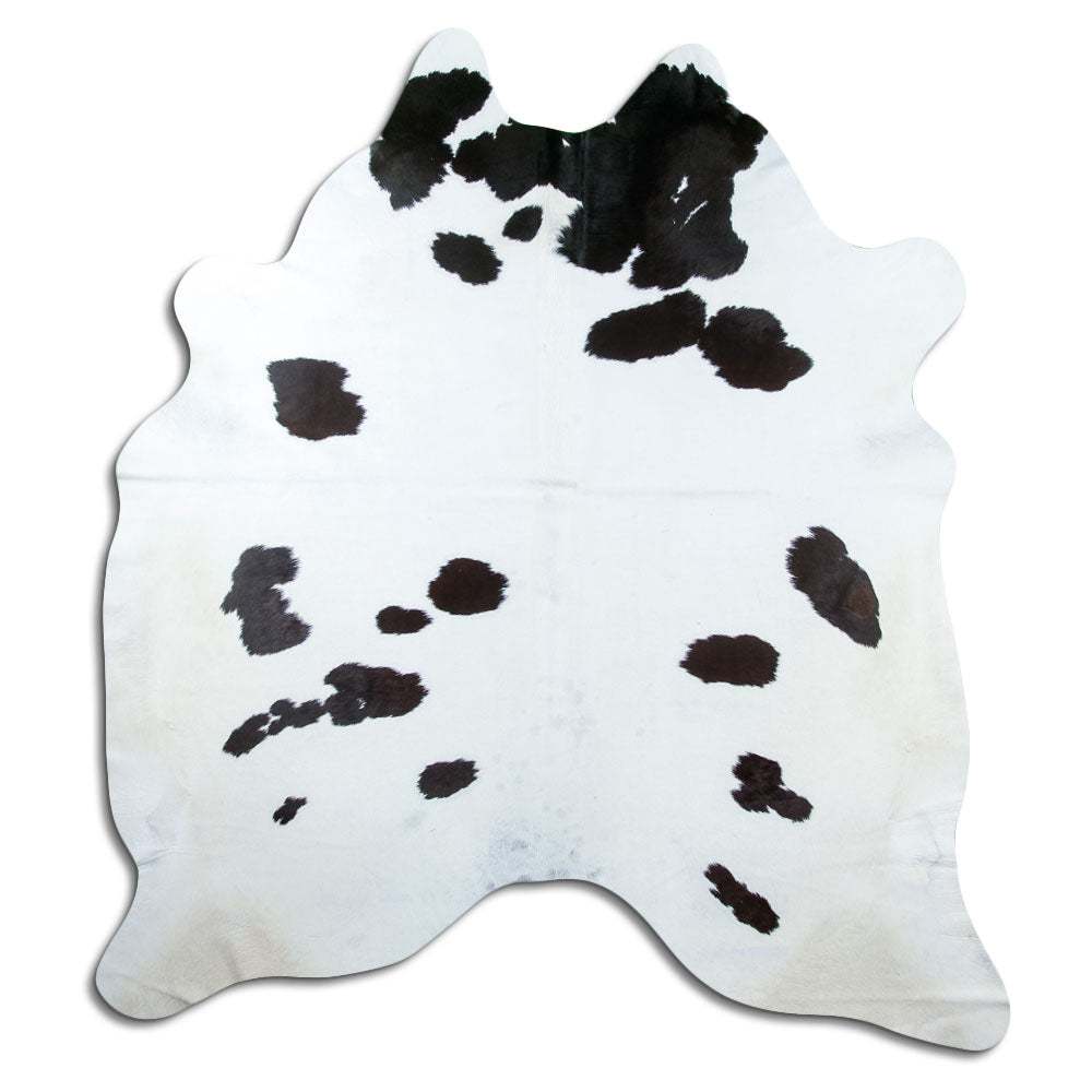 Black and white cowhide rug of about 220 × 210 cm, seen from above: the exact hide you receive
