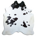 Black and white cowhide rug of about 220 × 210 cm, seen from above: the exact hide you receive