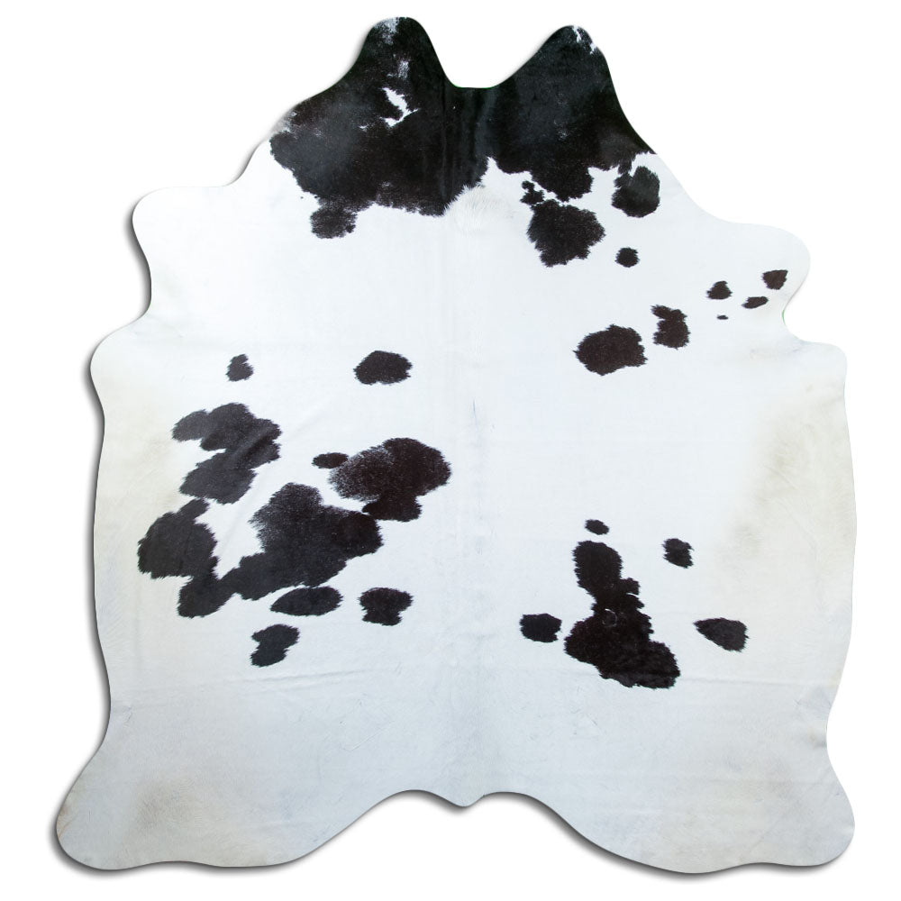 Black and white cowhide rug of about 220 × 210 cm, seen from above: the exact hide you receive