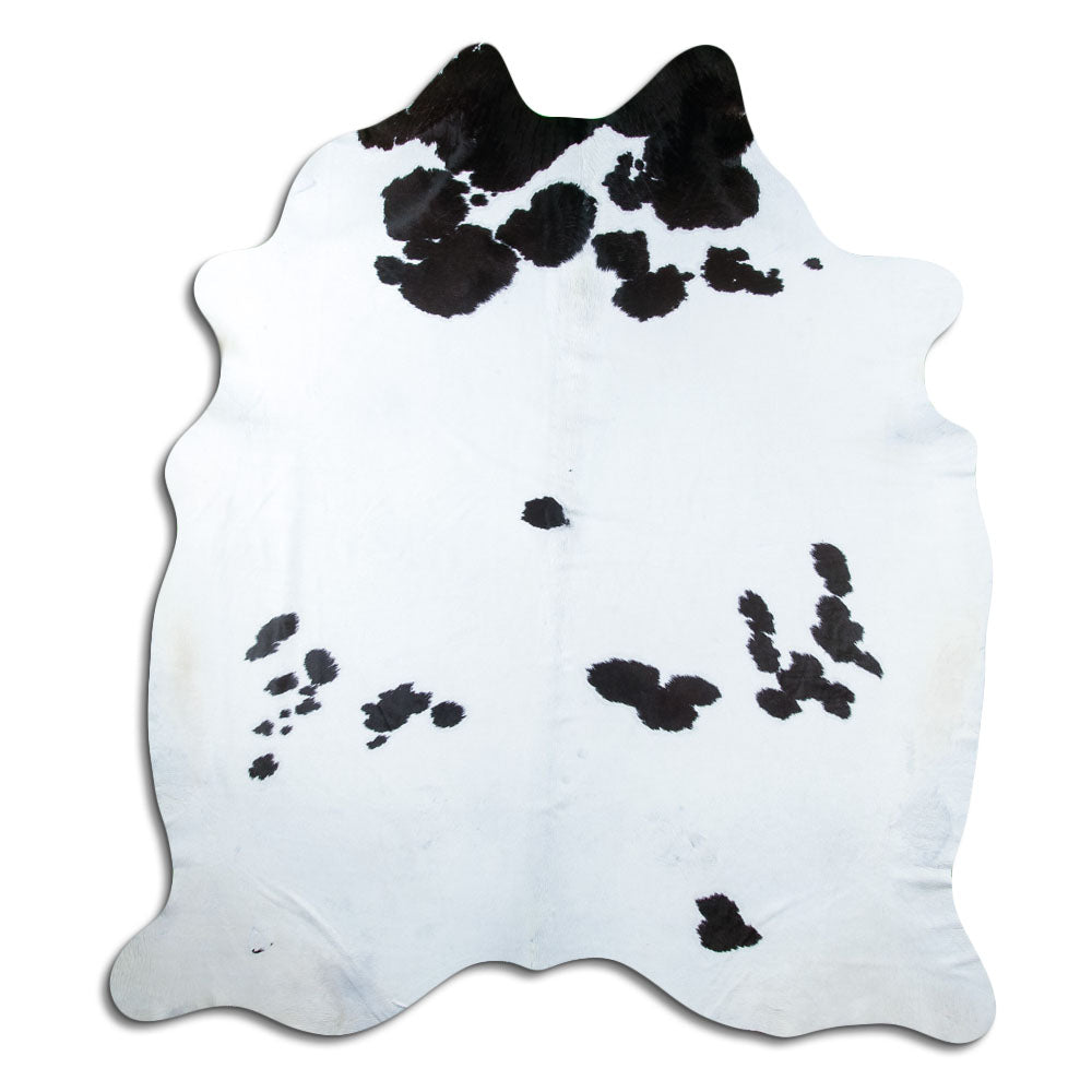 Black and white cowhide rug of about 240 × 210 cm, seen from above: the exact hide you receive