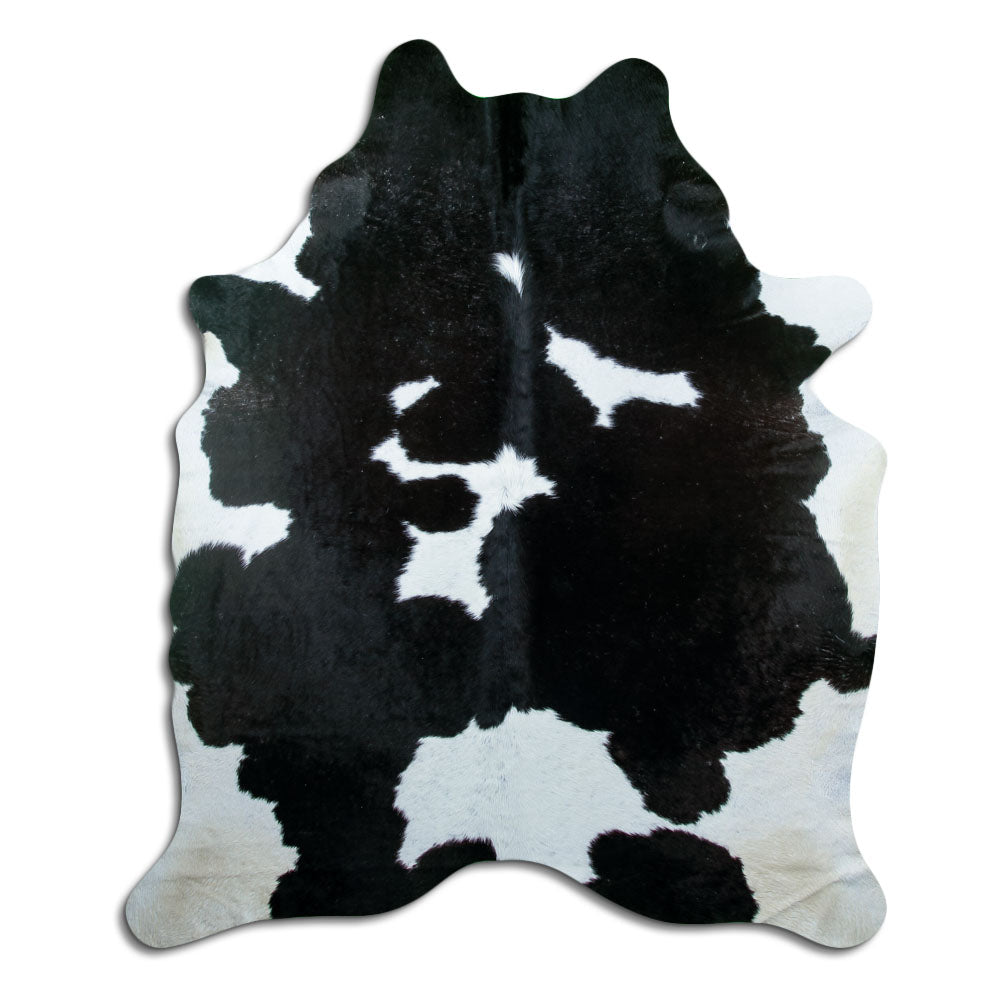 Black and white cowhide rug of about 220 × 190 cm, seen from above: the exact hide you receive
