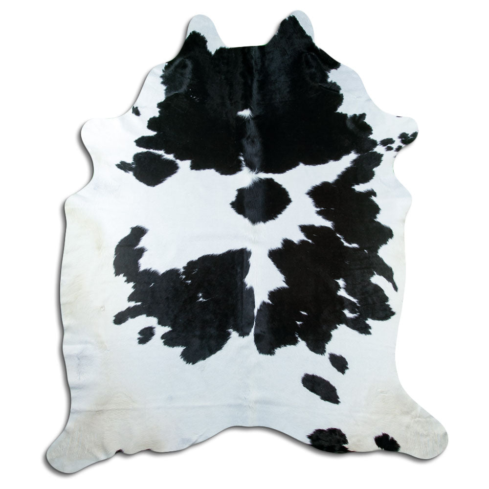 Black and white cowhide rug of about 240 × 210 cm, seen from above: the exact hide you receive