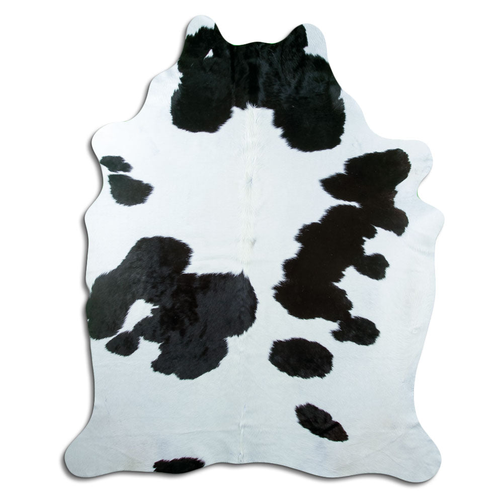 Black and white cowhide rug of about 230 × 180 cm, seen from above: the exact hide you receive