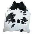 Black and white cowhide rug of about 240 × 210 cm, seen from above: the exact hide you receive