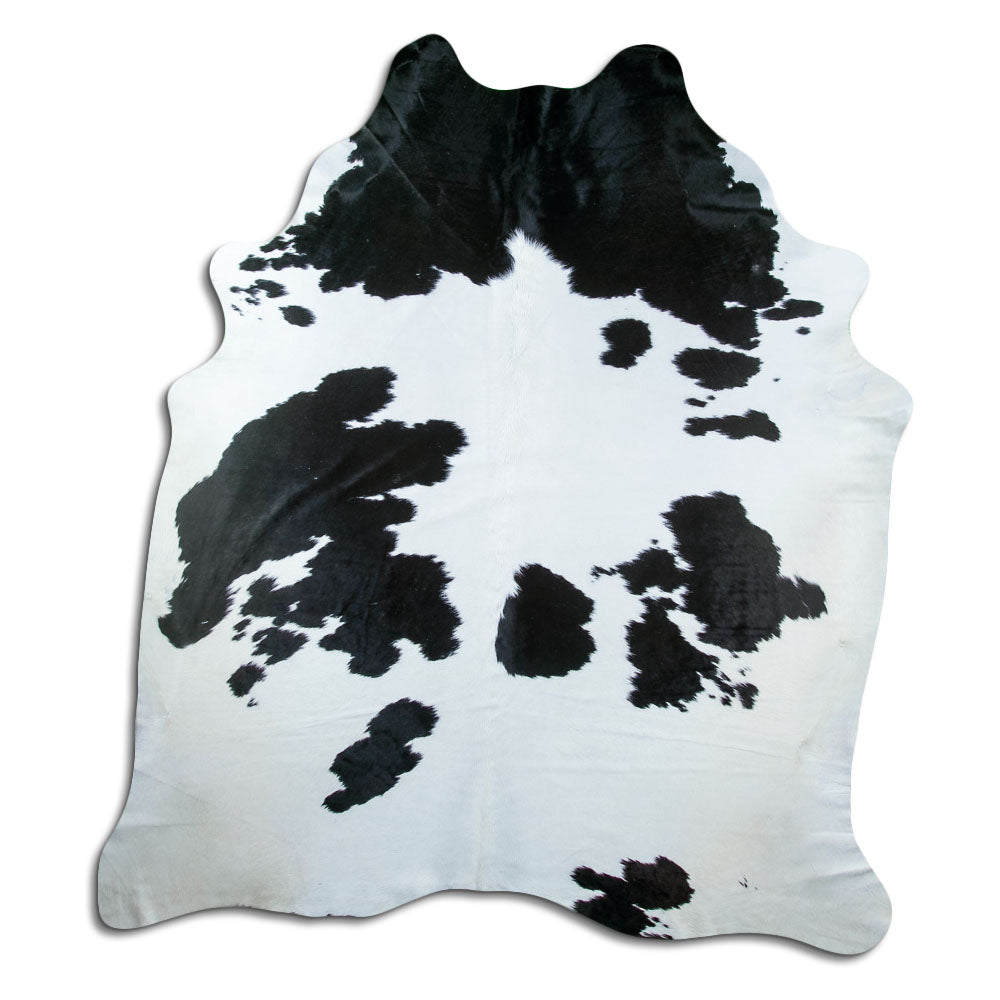 Black and white cowhide rug of about 240 × 210 cm, seen from above: the exact hide you receive