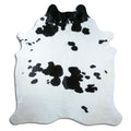 Black and white cowhide rug of about 220 × 210 cm, seen from above: the exact hide you receive