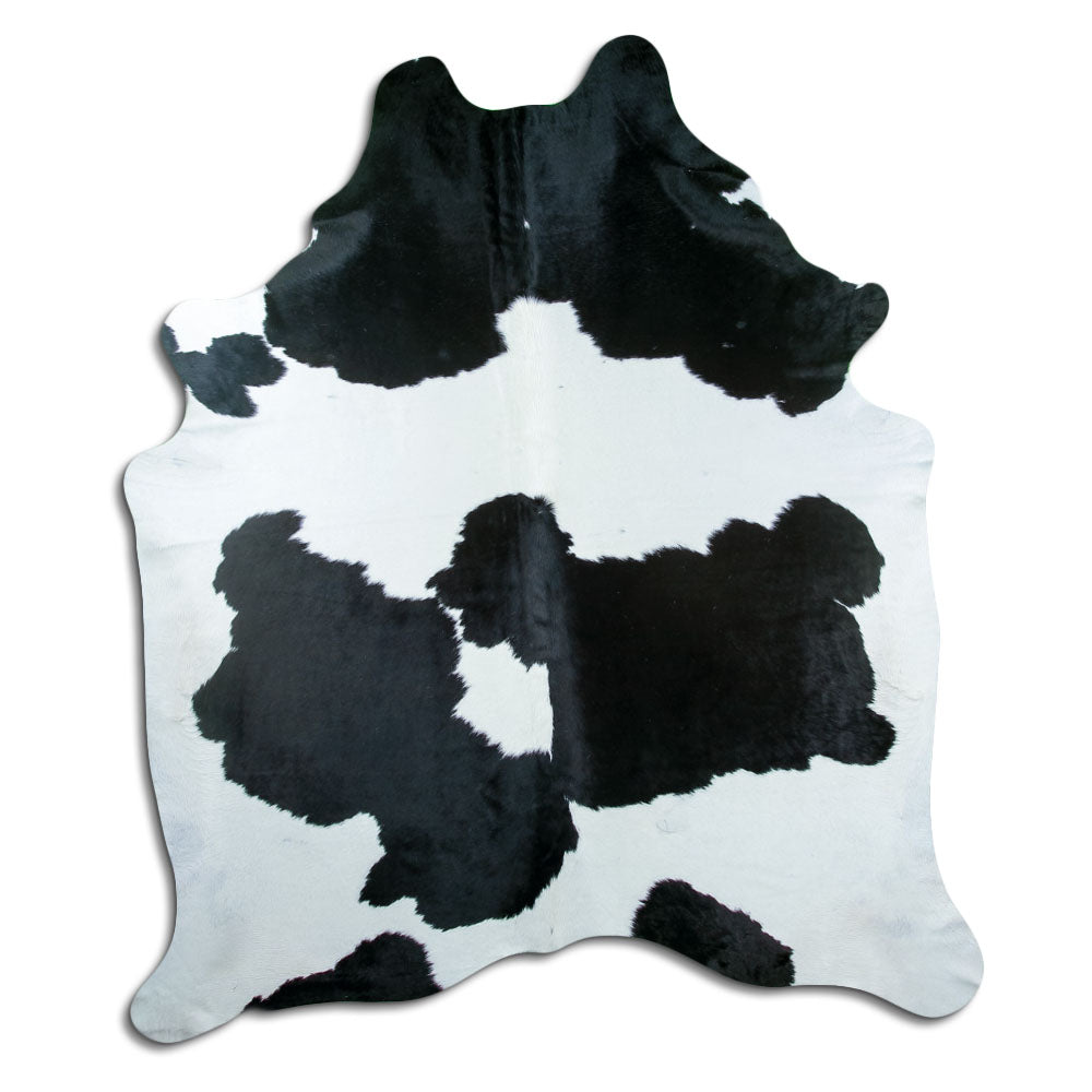 Black and white cowhide rug of about 230 × 190 cm, seen from above: the exact hide you receive