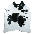 Black and white cowhide rug of about 210 × 190 cm, seen from above: the exact hide you receive