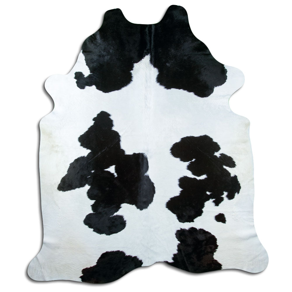 Black and white cowhide rug of about 250 × 220 cm, seen from above: the exact hide you receive