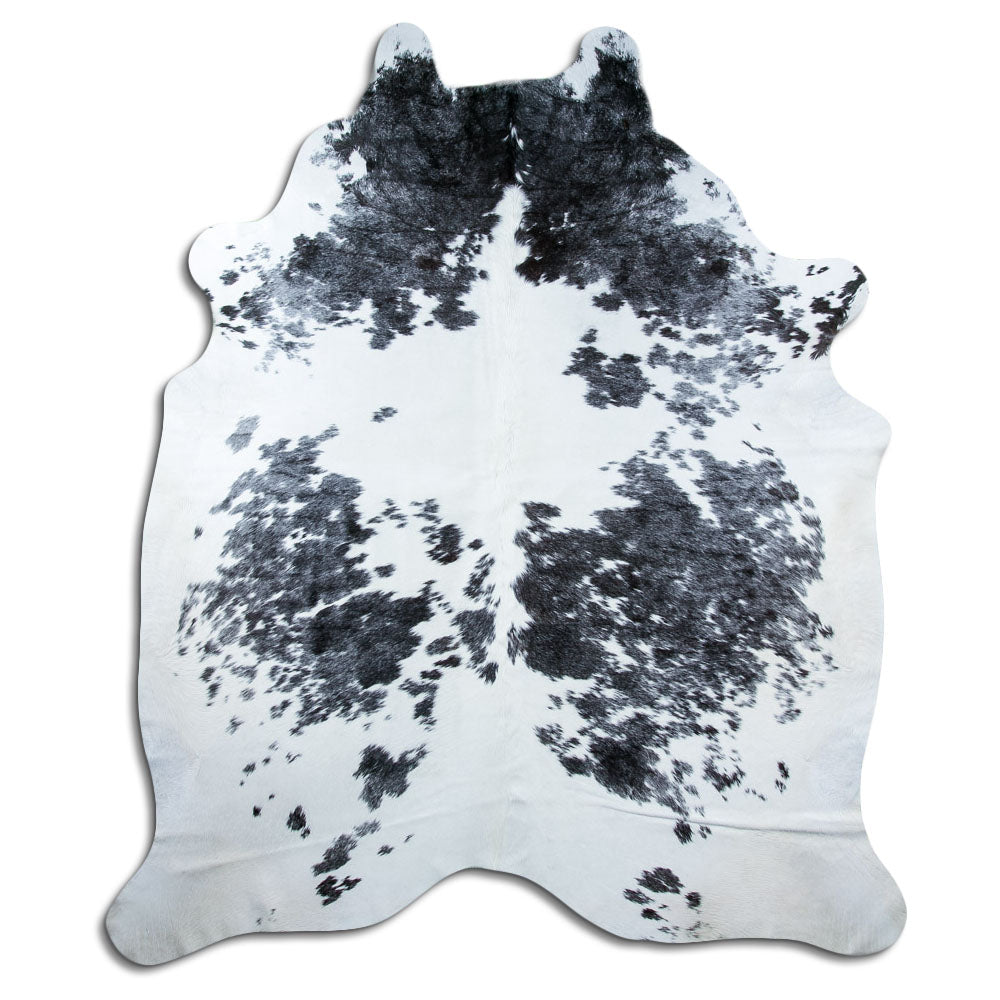 Black and white cowhide rug of about 240 × 200 cm, seen from above: the exact hide you receive