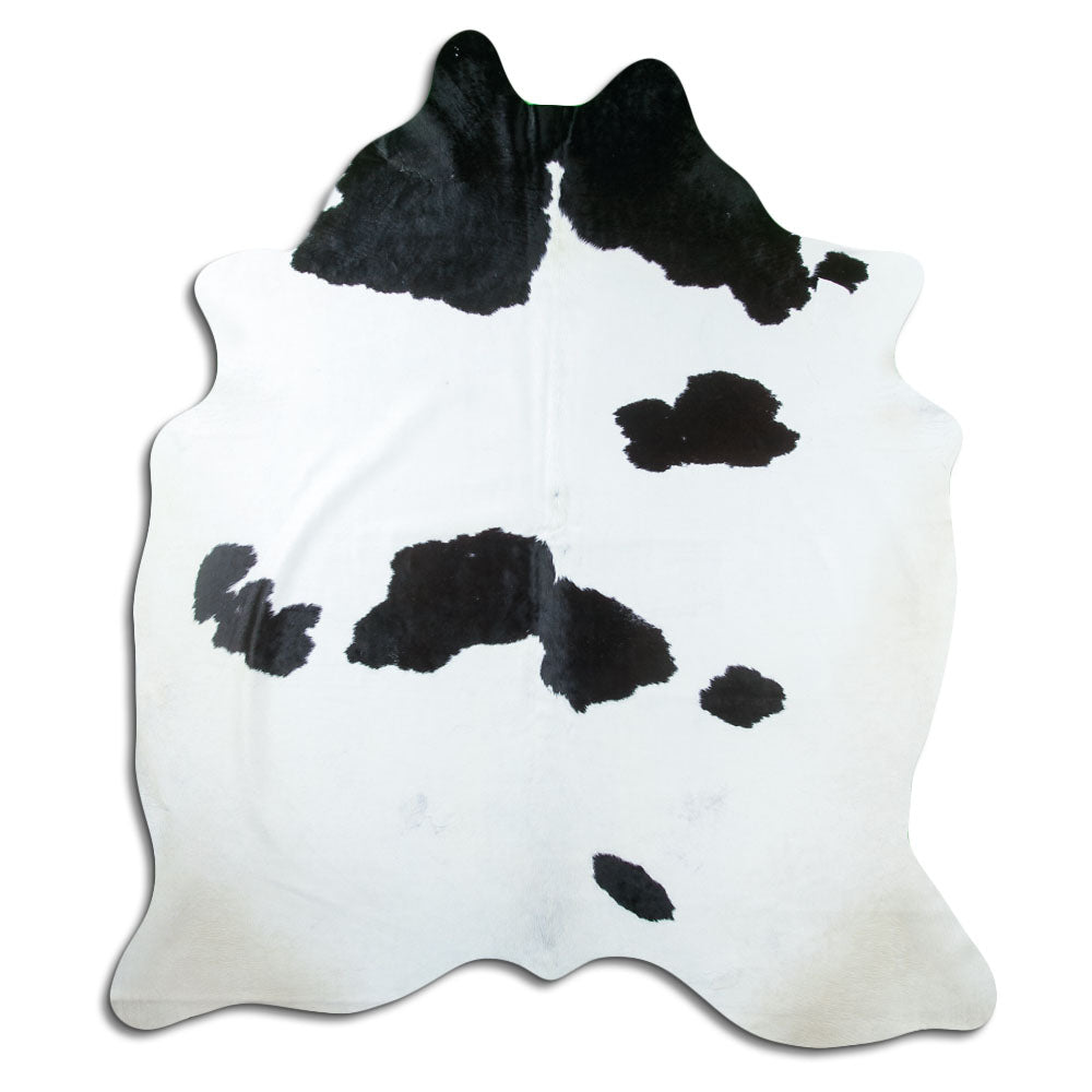 Black and white cowhide rug of about 210 × 190 cm, seen from above: the exact hide you receive