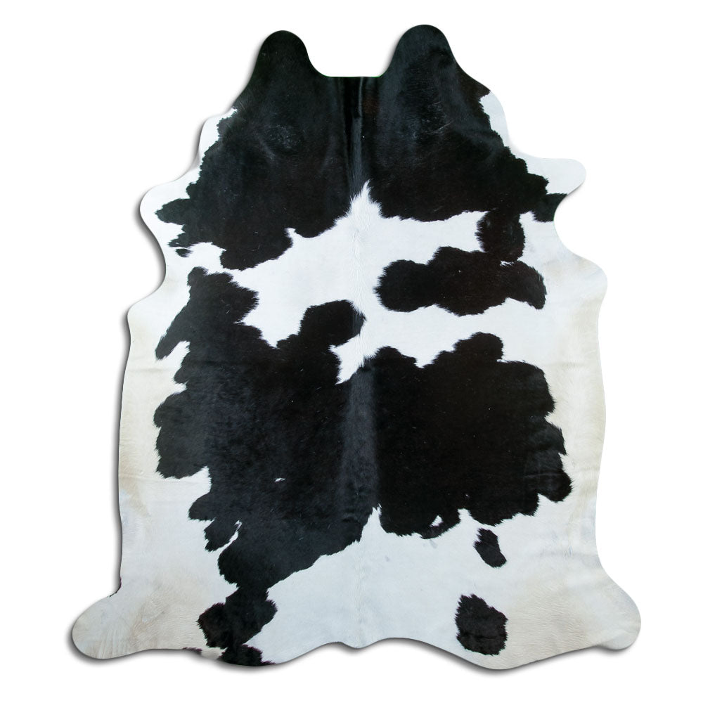 Black and white cowhide rug of about 220 × 190 cm, seen from above: the exact hide you receive