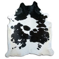 Black and white cowhide rug of about 240 × 210 cm, seen from above: the exact hide you receive