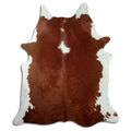 Brown and white cowhide rug of about 220 × 190 cm, seen from above: the exact hide you receive
