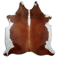 Brown and white cowhide rug of about 220 × 200 cm, seen from above: the exact hide you receive