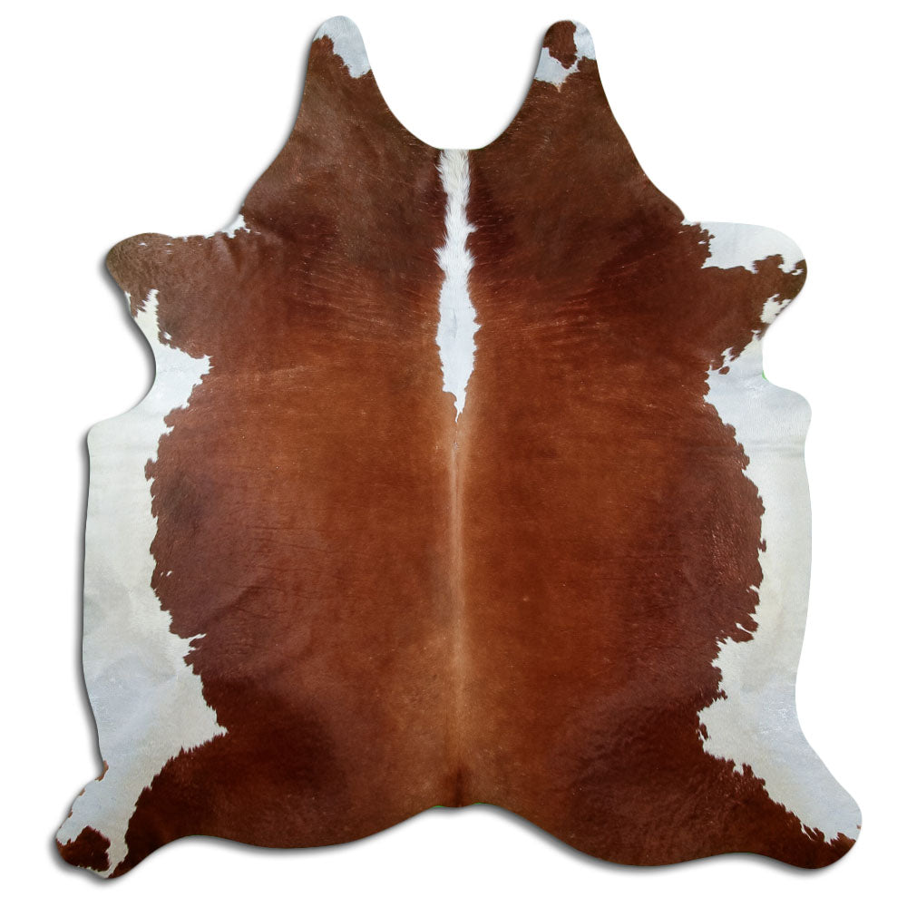 Brown and white cowhide rug of about 220 × 200 cm, seen from above: the exact hide you receive