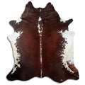 Brown and white cowhide rug of about 230 × 210 cm, seen from above: the exact hide you receive