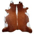Brown and white cowhide rug of about 240 × 230 cm, seen from above: the exact hide you receive