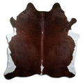Brown and white cowhide rug of about 210 × 200 cm, seen from above: the exact hide you receive