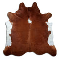Brown and white cowhide rug of about 230 × 220 cm, seen from above: the exact hide you receive