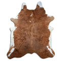 Brown and white cowhide rug of about 230 × 190 cm, seen from above: the exact hide you receive