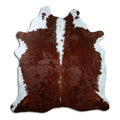Brown and white cowhide rug of about 210 × 200 cm, seen from above: the exact hide you receive