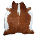 Brown and white cowhide rug of about 220 × 200 cm, seen from above: the exact hide you receive