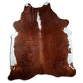 Brown and white cowhide rug of about 240 × 210 cm, seen from above: the exact hide you receive
