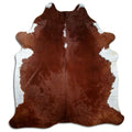 Brown and white cowhide rug of about 240 × 210 cm, seen from above: the exact hide you receive