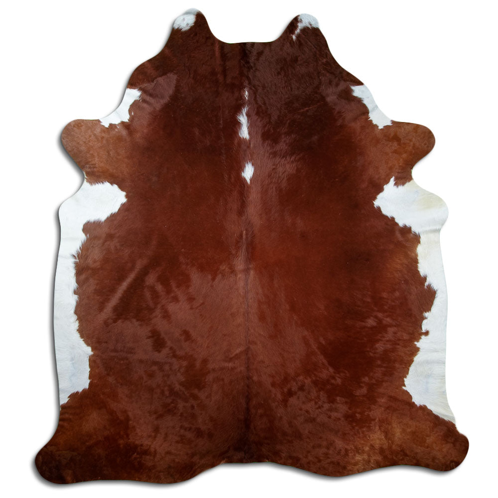 Brown and white cowhide rug of about 240 × 210 cm, seen from above: the exact hide you receive