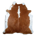 Brown and white cowhide rug of about 220 × 210 cm, seen from above: the exact hide you receive