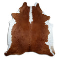 Brown and white cowhide rug of about 220 × 200 cm, seen from above: the exact hide you receive