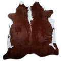 Brown and white cowhide rug of about 230 × 220 cm, seen from above: the exact hide you receive