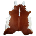 Brown and white cowhide rug of about 230 × 190 cm, seen from above: the exact hide you receive