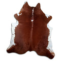 Brown and white cowhide rug of about 220 × 190 cm, seen from above: the exact hide you receive
