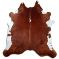 Brown and white cowhide rug of about 230 × 220 cm, seen from above: the exact hide you receive