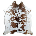 Brown and white cowhide rug of about 190 × 170 cm, seen from above: the exact hide you receive