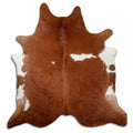Brown and white cowhide rug of about 230 × 220 cm, seen from above: the exact hide you receive