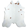 Brown and white cowhide rug of about 220 × 200 cm, seen from above: the exact hide you receive