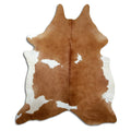 Brown and white cowhide rug of about 220 × 190 cm, seen from above: the exact hide you receive