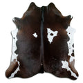Brown and white cowhide rug of about 200 × 190 cm, seen from above: the exact hide you receive