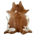 Brown and white cowhide rug of about 220 × 190 cm, seen from above: the exact hide you receive