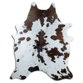 Brown and white cowhide rug of about 230 × 180 cm, seen from above: the exact hide you receive
