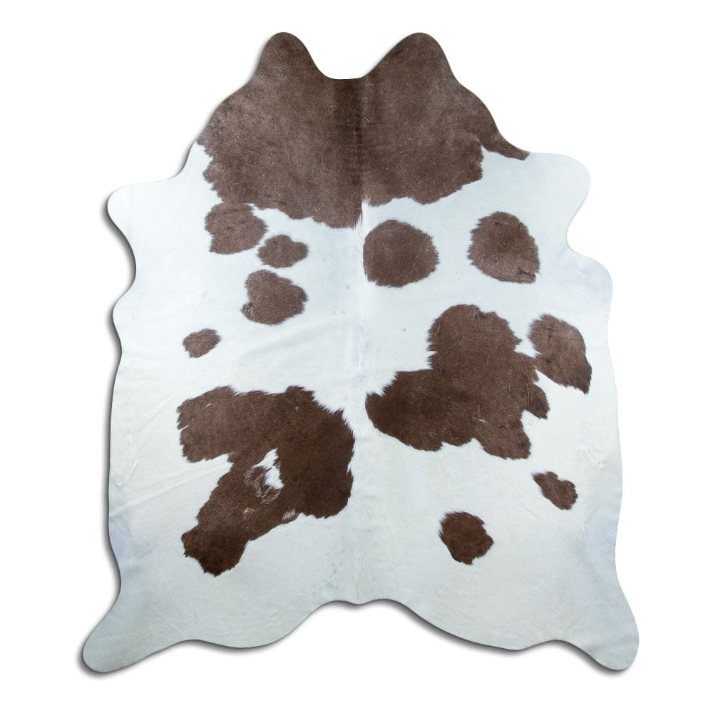 Brown and white cowhide rug of about 210 × 180 cm, seen from above: the exact hide you receive
