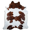 Brown and white cowhide rug of about 230 × 200 cm, seen from above: the exact hide you receive