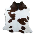 Brown and white cowhide rug of about 200 × 180 cm, seen from above: the exact hide you receive