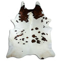 Brown and white cowhide rug of about 250 × 210 cm, seen from above: the exact hide you receive