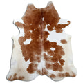 Brown and white cowhide rug of about 220 × 200 cm, seen from above: the exact hide you receive