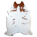 Brown and white cowhide rug of about 220 × 180 cm, seen from above: the exact hide you receive